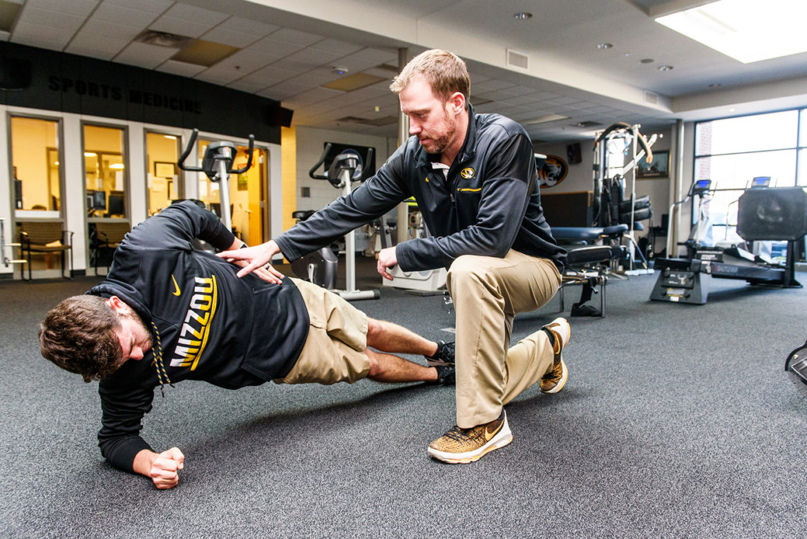 Physical Therapist Andrew Turpin works with Mizzou golfers.